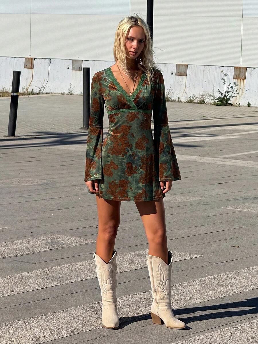 Full front view of green floral faux-wrap mini dress with high waist and long bell sleeves