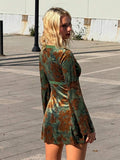 Rear three-quarter view of green botanical velvet mini dress showing lace trim and flared cuffs