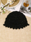 Close view of black hollow out crochet hat with shiny floral finish