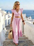 Front view of pink striped crop top and wide leg pants vacation set