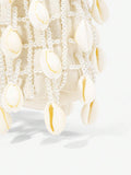 Small cream beaded hobo bag showing beige straps and curved top handle