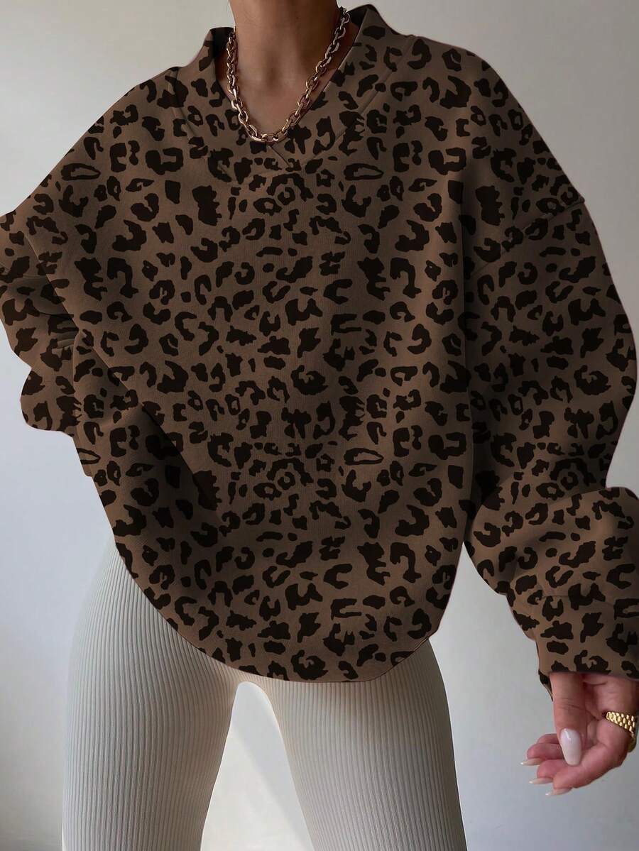 Front worn view of chocolate brown leopard-print V-neck sweatshirt with balloon sleeves
