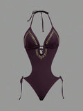 Front studio view of dark burgundy halter studded cutout one-piece swimsuit with deep V neckline and hip ties for beach party styling