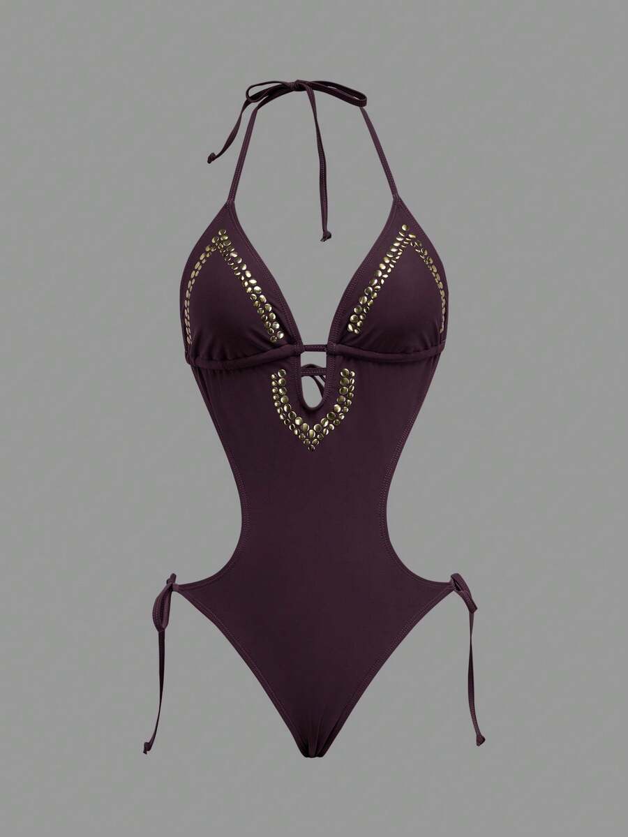Front studio view of dark burgundy halter studded cutout one-piece swimsuit with deep V neckline and hip ties for beach party styling