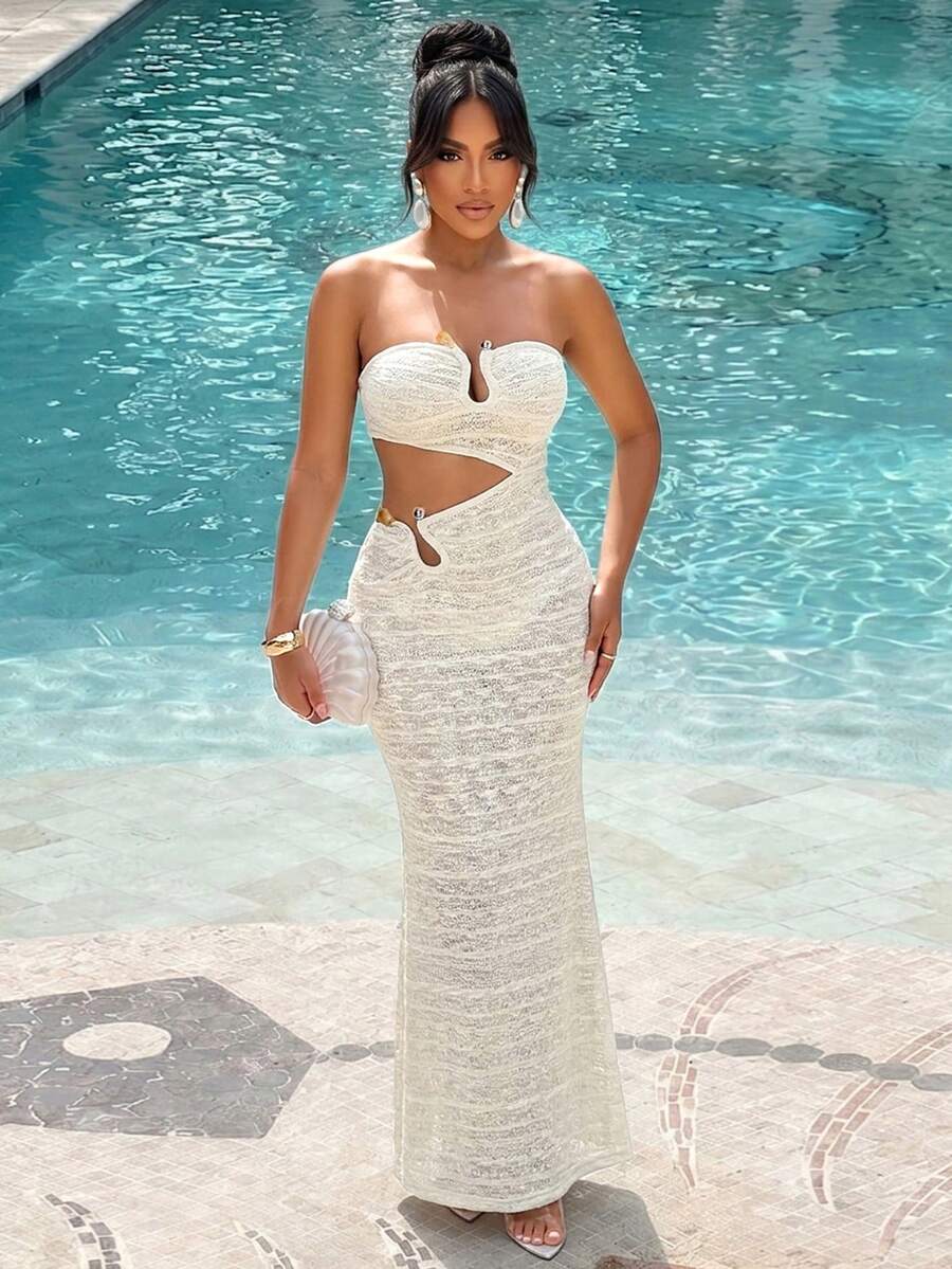 Front view of ivory textured strapless bodycon maxi dress with asymmetric cutouts and metal accents