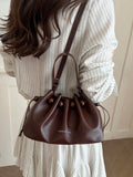 Size chart for brown drawstring bucket bag showing compact dimensions
