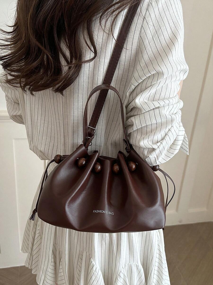 Size chart for brown drawstring bucket bag showing compact dimensions