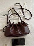 Brown ruched bucket crossbody bag with Fashion and Bag front text