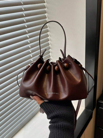 Dark brown small drawstring bucket shoulder bag with wood bead trim and top handle