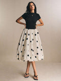 Black fitted bodice and white polka-dot bubble skirt dress