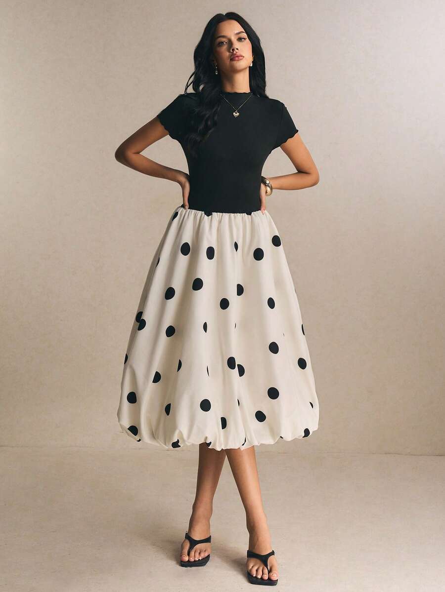 Black fitted bodice and white polka-dot bubble skirt dress