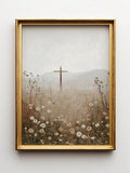 Gold framed cross and white wildflower landscape canvas on a white wall