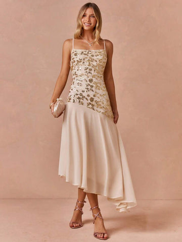 Side view of ivory gold formal dress with diagonal dropped waist and floaty asymmetric hem