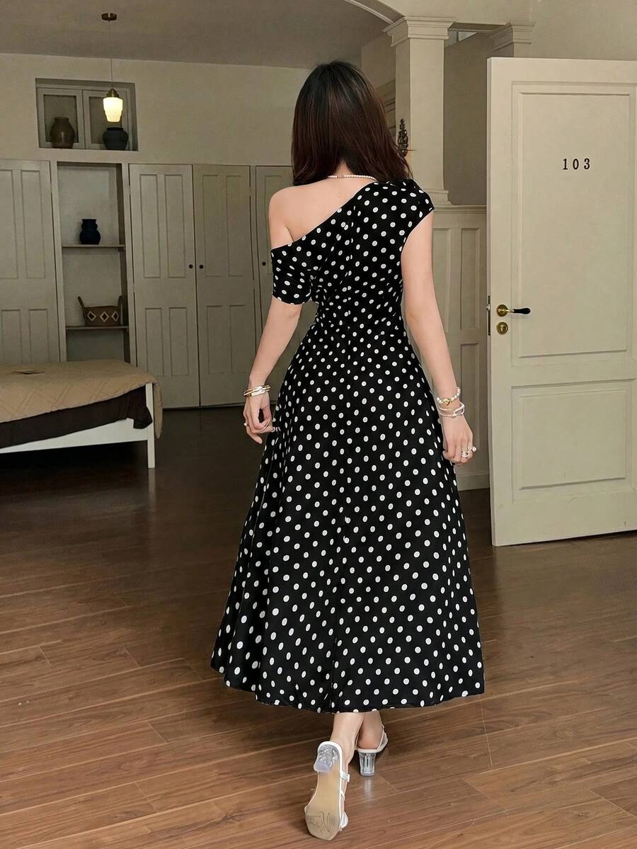 Front close-up of black polka dot one shoulder maxi dress