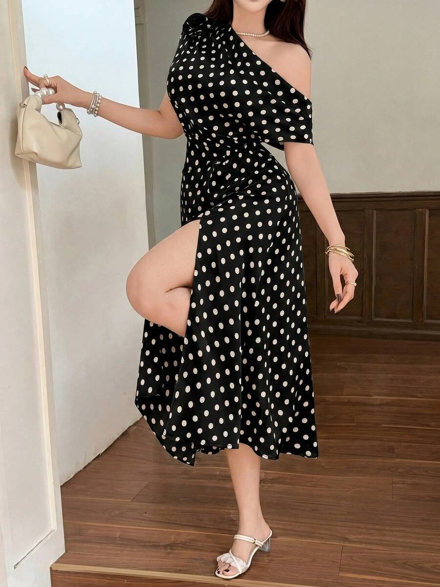 Front view of black polka dot maxi dress with side slit