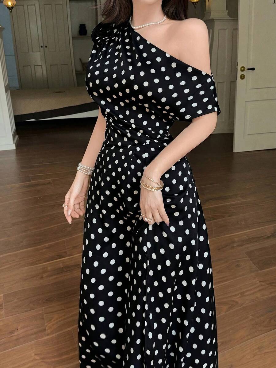 Front close-up of black polka dot one shoulder maxi dress