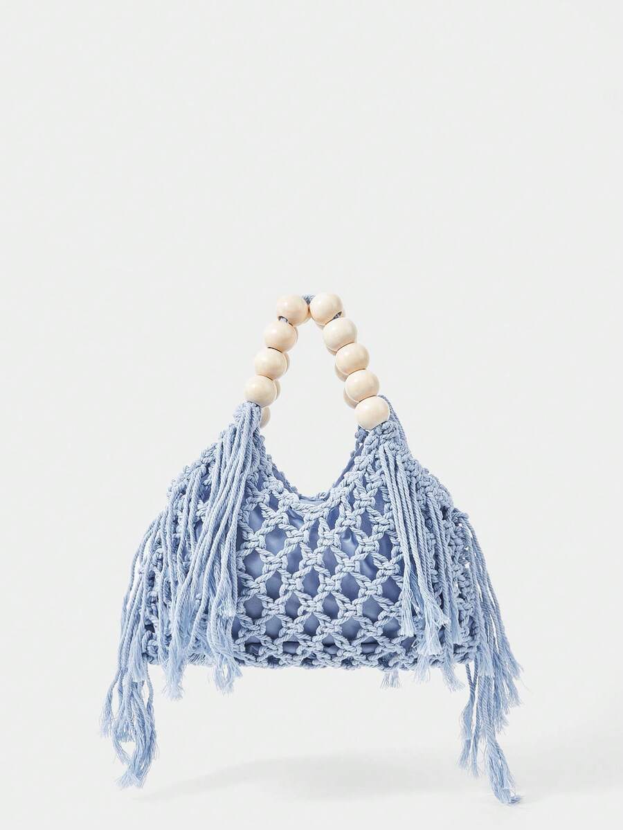 Light blue crochet beach bag front view with hollow weave long tassels and cream bead handle