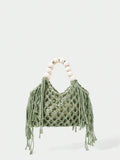 Green crochet beach bag front view with hollow weave side tassels and cream bead handle