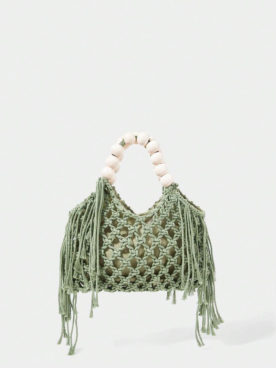 Green crochet beach bag front view with hollow weave side tassels and cream bead handle