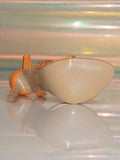 Bottom view orange stiletto sandal showing beige textured outsole and heel tip