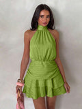 Front view of green halter mini dress with gathered waist and tiered hem