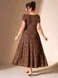 Back view of coffee brown floral jacquard midi dress with scoop back, flutter sleeves, and softly flared skirt