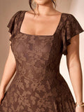 Close-up of coffee brown jacquard dress bodice with square neckline, layered flutter sleeves, and fitted waist