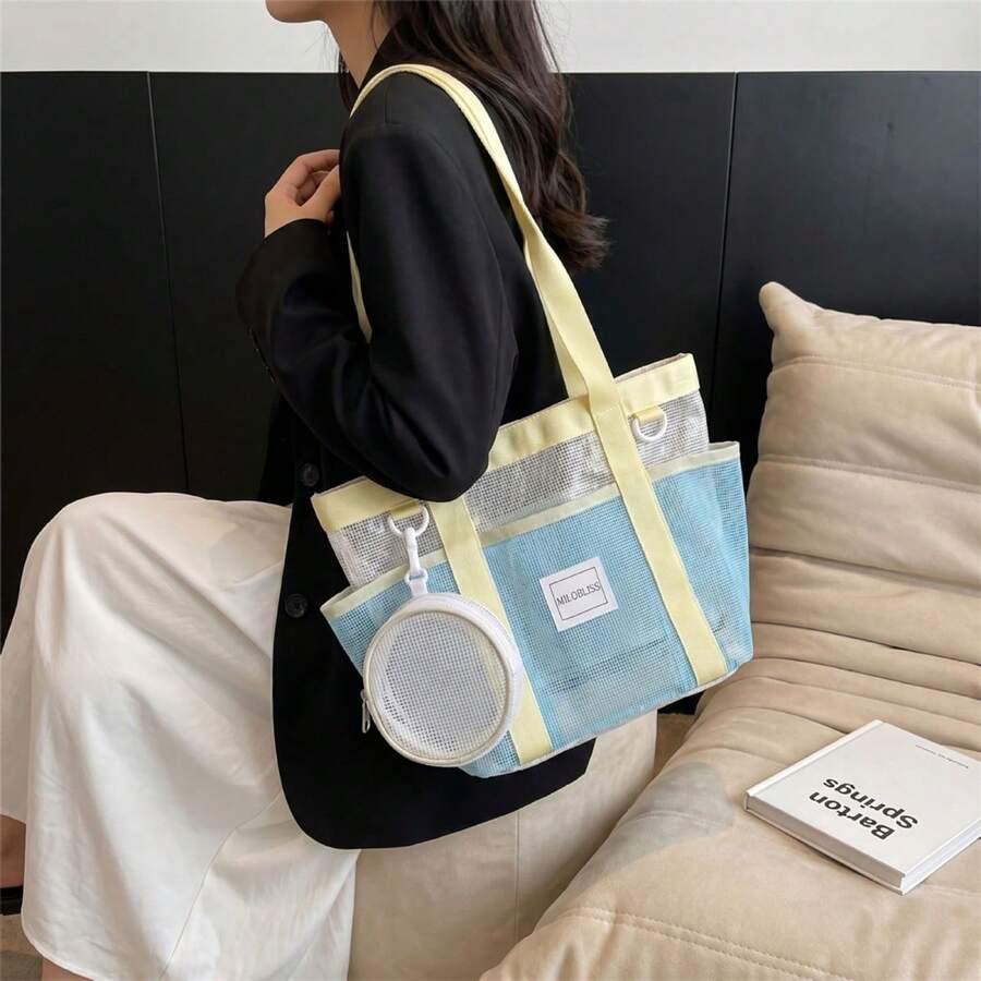 Front shoulder view of light blue mesh tote bag with yellow trim and round clip pouch