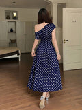 Back view of navy polka dot A-line maxi dress