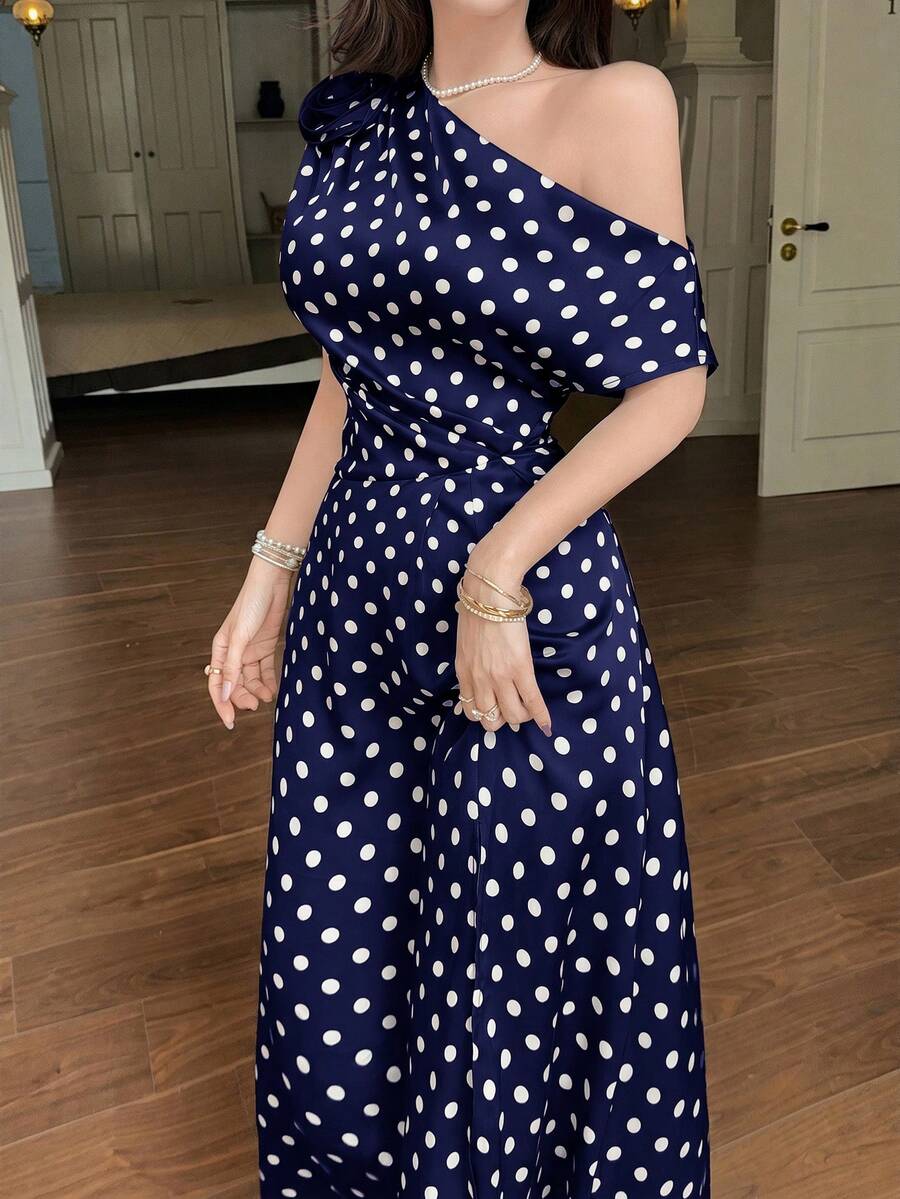 Front close-up of navy polka dot one shoulder maxi dress