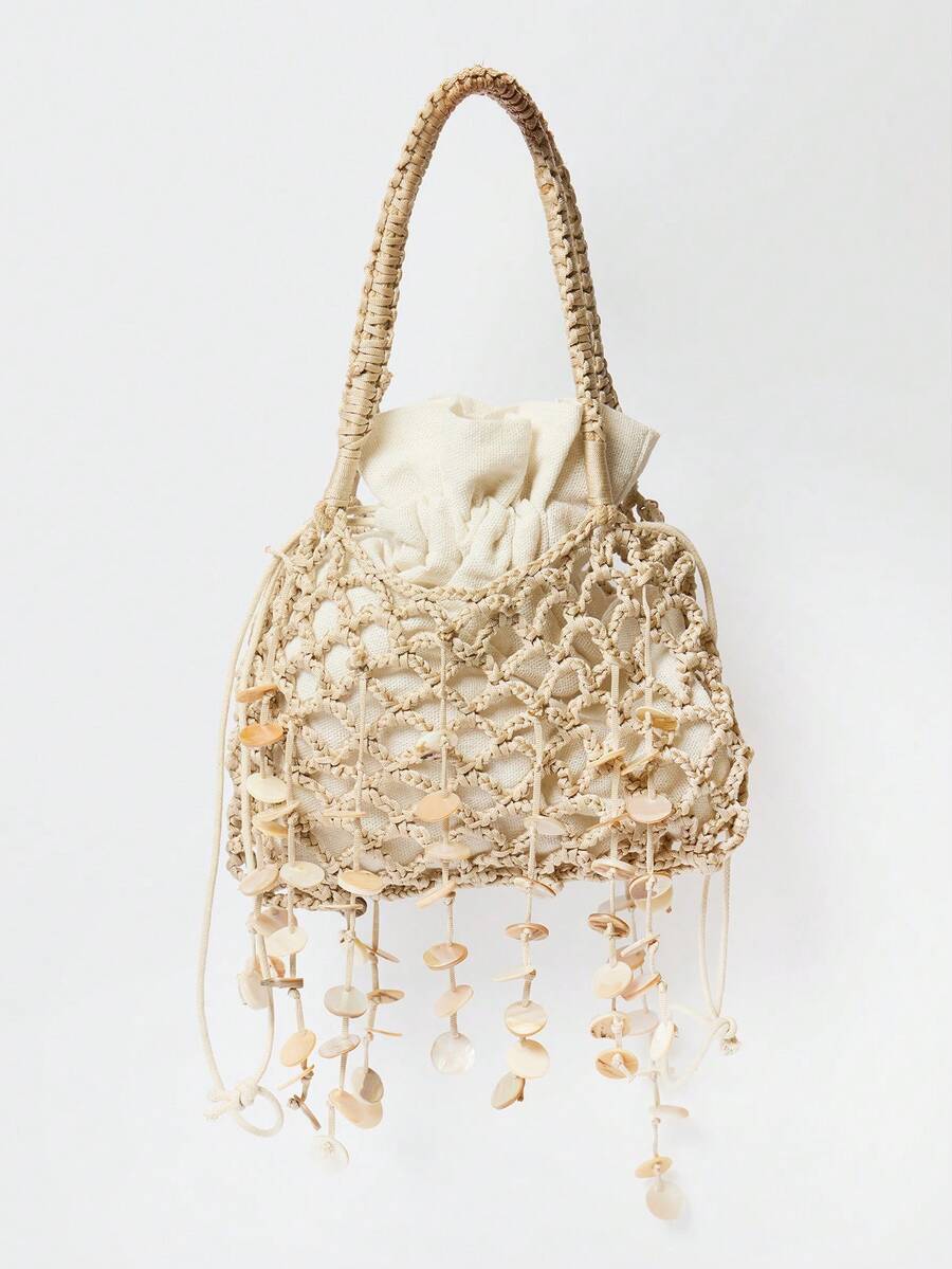 Neutral crochet tote bag showing dangling round shell fringe and drawstring pouch