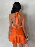 Back view of orange halter mini dress with tied neck and open V back