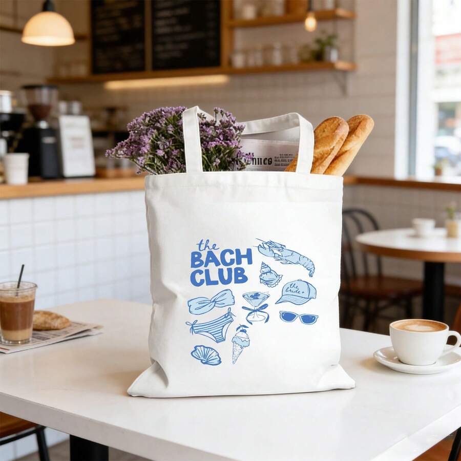 Cafe lifestyle view of white bridal party canvas tote filled with flowers and baguettes