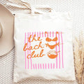 Flat lay front view of beige canvas bachelorette tote with pink The Bach Club graphic