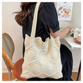 Side lifestyle view of cream crochet woven shoulder bag with raised hexagon motifs