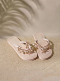Top angled view of beige platform thong sandals with pearl chains, rhinestones and layered soles for beach styling