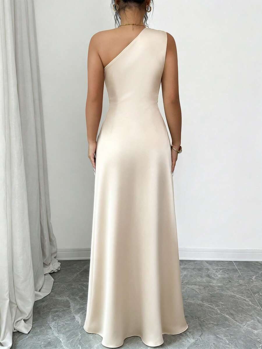 Champagne satin one-shoulder maxi dress with gold floral brooches and draped peplum