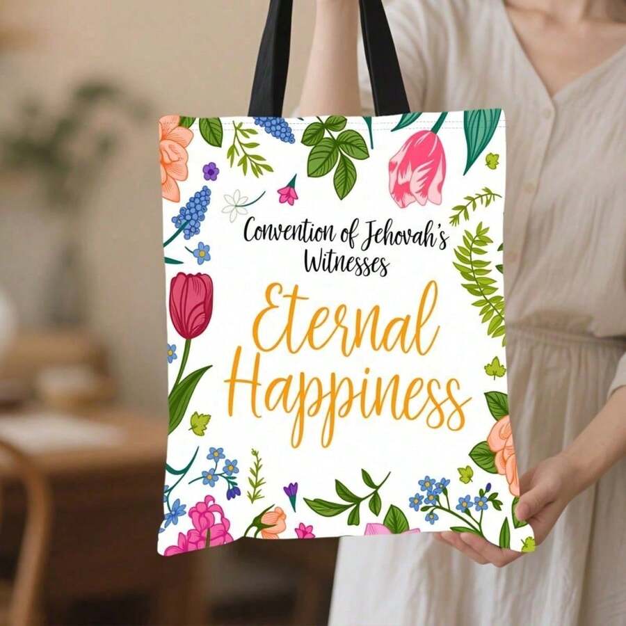 Front held view of white floral Jehovahs Witness Eternal Happiness tote bag with black straps