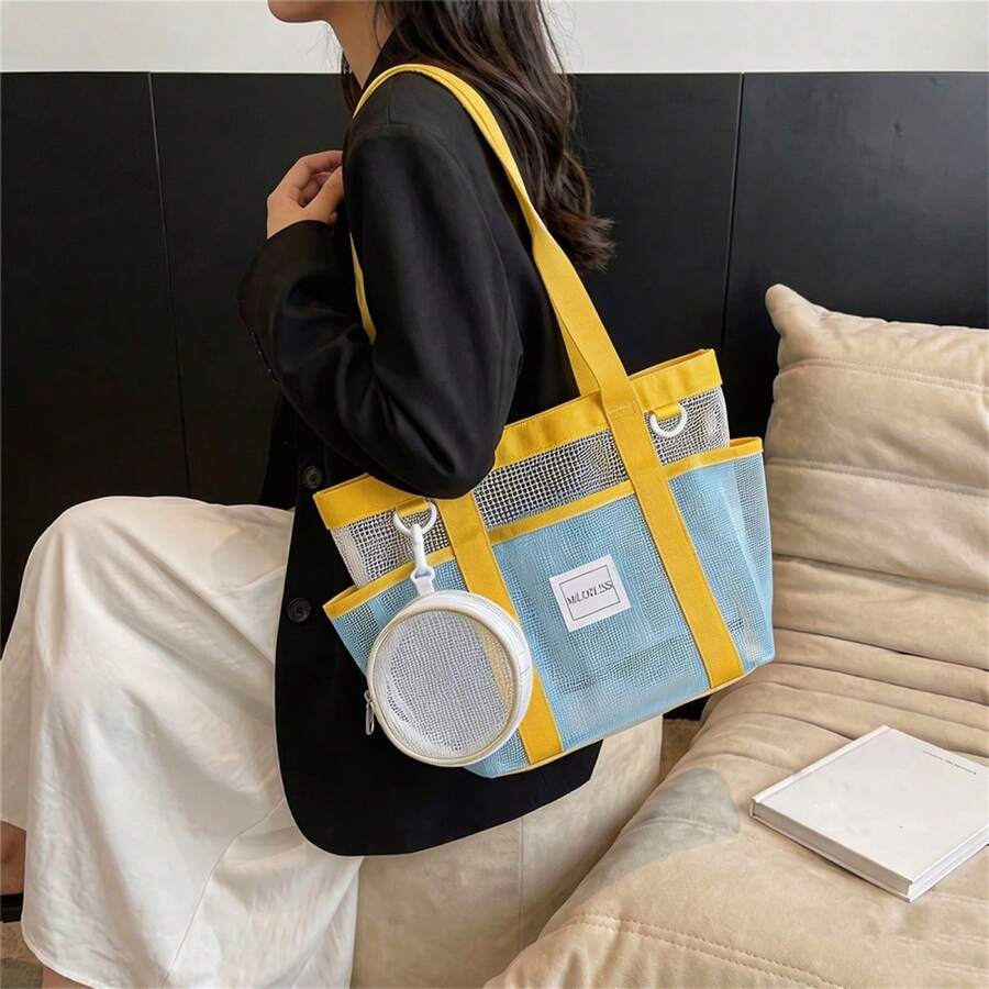 Side lifestyle view of colorblock mesh shoulder tote bag with cream trim and clip pouch