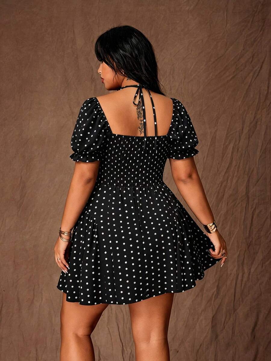 Rear view of black and white polka-dot mini dress with tie straps, smocked back and puff sleeves