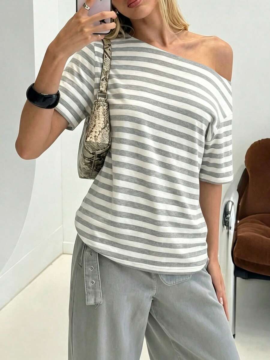 Front worn view of grey and white striped oversized T-shirt with wide neckline