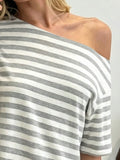 Close-up of wide neckline and grey horizontal stripes on oversized short-sleeve T-shirt