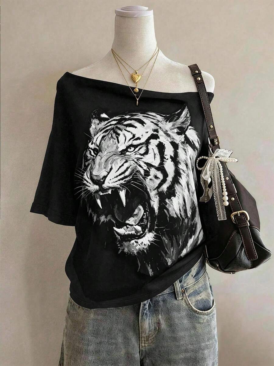 Front styled view of black oversized wide-neck T-shirt with roaring tiger graphic