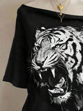Close-up of monochrome roaring tiger print on black wide-neck graphic T-shirt