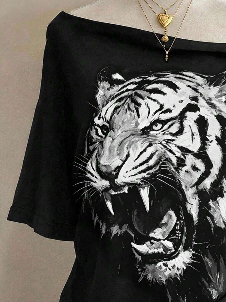 Close-up of monochrome roaring tiger print on black wide-neck graphic T-shirt