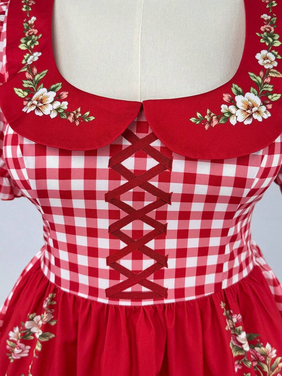 Close-up of gingham floral dress collar and decorative crisscross bodice detail