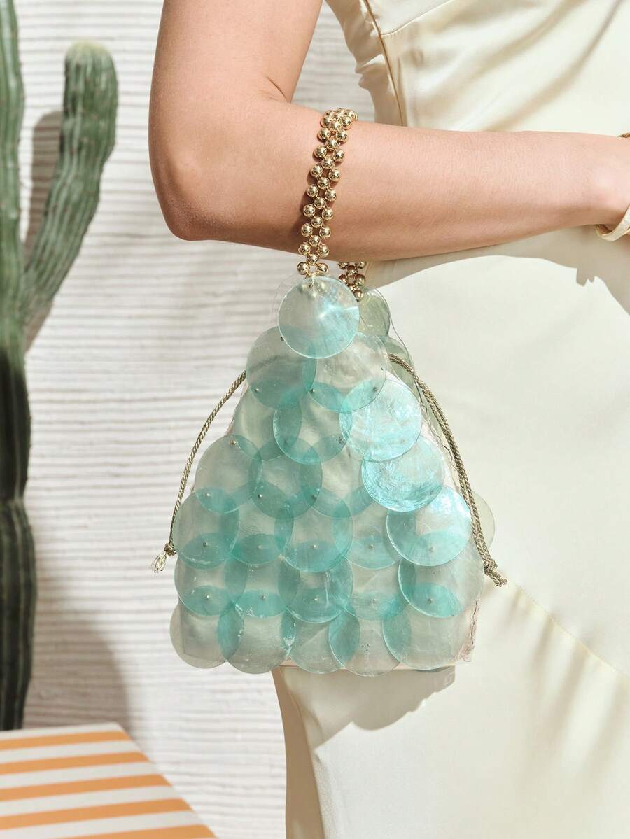 Blue mermaid scale shell handbag with overlapping translucent discs and gold drawstring