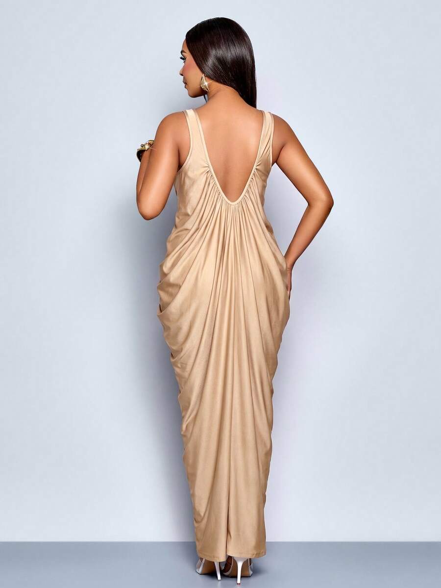 Front angled view of champagne deep V ruched maxi dress with draped silhouette