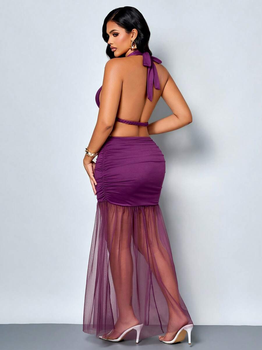 Front full-length view of purple halter bodycon maxi dress with sheer asymmetrical skirt