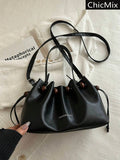 Black small drawstring bucket shoulder bag with wood bead trim and top handle